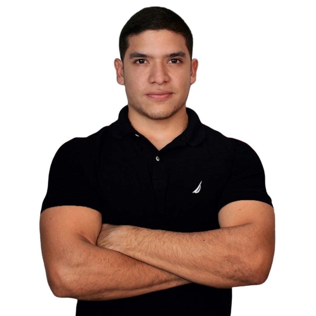Man wearing a black polo shirt with arms crossed, looking at the camera against a white background.